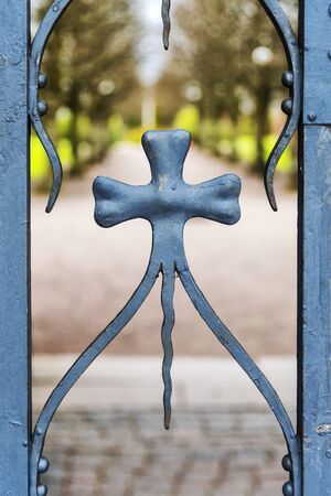 Close up view of a decorative gate that secures the grounds to a graveyard.の写真素材