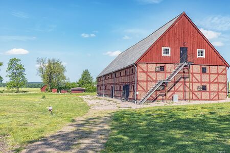 An old red brick barn set in the rural countryside of Swedens Halland region.の写真素材