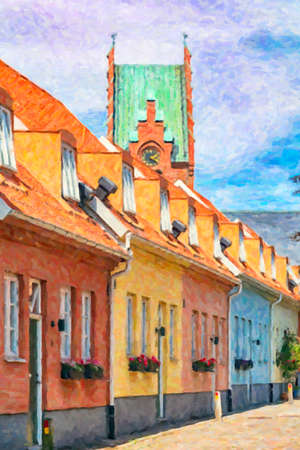 A row of pastel painted houses in Trelleborg, Sweden. The church in the background.