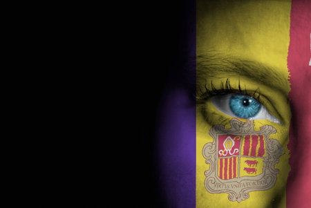 A young female with the flag of Andorra painted on her face on her way to a sporting event to show her support.の写真素材