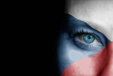 A young female with the flag of Czech Republic painted on her face on her way to a sporting event to show her support.の写真素材