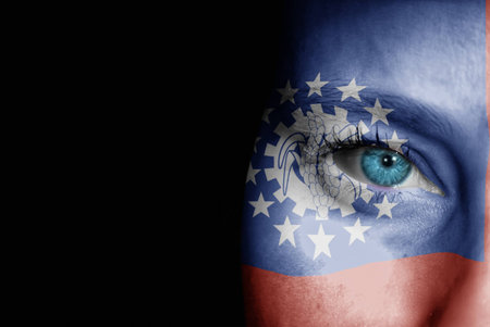 A young female with the flag of Burma painted on her face on her way to a sporting event to show her support.の写真素材