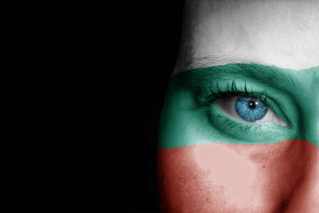 A young female with the flag of Bulgaria painted on her face on her way to a sporting event to show her support.の写真素材
