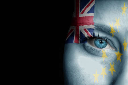 A young female with the flag of Tuvalu painted on her face on her way to a sporting event to show her support.の写真素材