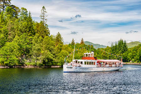 LOCH KATRINE, SCOTLAND - July 09: The Sir Walter Scott steamship brings its passengers back to dock after a tour of Loch Katrine in Scotland.のeditorial素材
