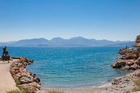 A dramatic view of a mountain range from across the water on the greek island of crete.の写真素材