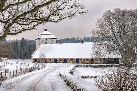 View of a snow covered Hovdala Castle in Hassleholm region. Hovdala Castle is a castle in Hassleholm Municipality, Scania, in southern Sweden.の写真素材