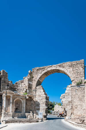 Entrance gate to the city amongst the ruins of Ancient Side, Antalaya, Turkey.の写真素材