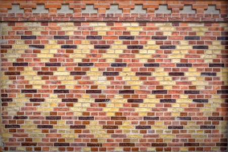Ornamentally designed patterned brick wall on the side of a building.の写真素材