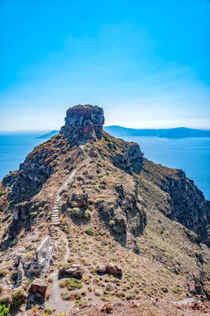 A view of santorini overlooking the rock of skaros with the volcano in the background.の写真素材