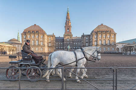 COPENHAGEN, DENMARK - DECEMBER 24, 2016: Horses and cart with rider at Christianborg palace...