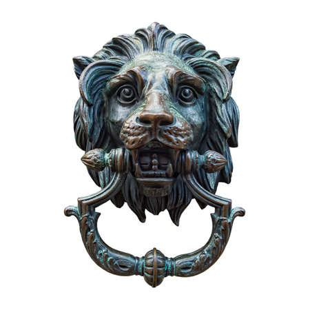 A classic lion head door knocker made out of metal and isolated against a white background.の写真素材