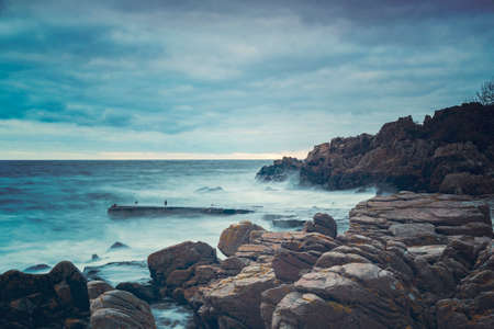 Rocky beach landscape at dusk. Kullaberg, Sweden.の写真素材
