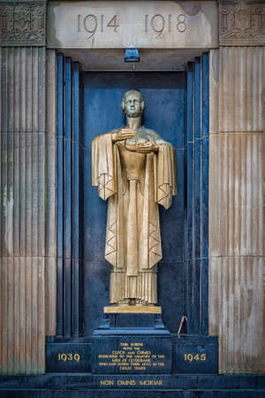 The bronze war memorial on the side of the town hall building in Clydebank, Scotlandの写真素材