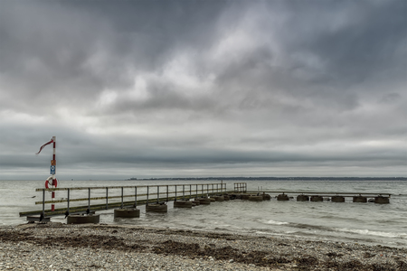 An old pier at Larod beach outside Helsingborg, overlooking the oresund towards Denmark.の写真素材