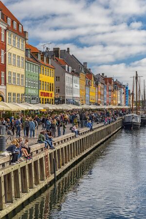 COPENHAGEN, DENMARK - SEPTEMBER 21, 2019: Copenhagen waterfront, canal and entertainment district lined by brightly colored 17th and 18th century townhouses.のeditorial素材