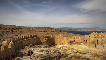 LINDOS, GREECE - OCTOBER 04, 2018: Some tourists at the Lindos acropolis on the Greek island of Rhodes.のeditorial素材