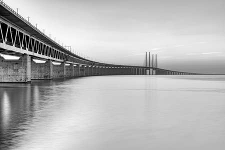 HELSINGBORG, SWEDEN - SEPTEMBER 25, 2020: A long exposure photograph at dusk in the city, meanwhile a pedestrian waits to cross the road.のeditorial素材