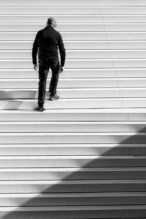 A lone man climbs the steps alone in the city.のeditorial素材