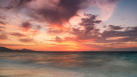 Long exposure photograhy at the rocky Kato Petres Beach landscape at dusk. Rhodes, Greeceの写真素材
