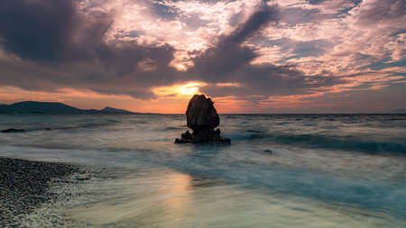 Long exposure photograhy at the rocky Kato Petres Beach landscape at dusk. Rhodes, Greeceの写真素材
