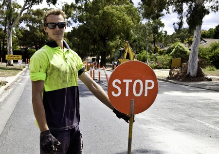 Roadworker controls traffic flow