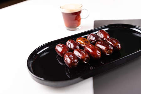 Close up of Dates fruit in a black elegant plateの写真素材
