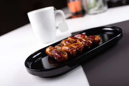 Close up of Dates fruit in a black elegant plateの写真素材
