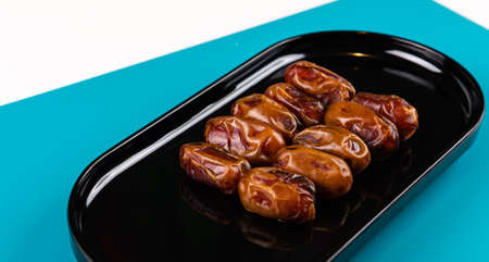 Close up of Dates fruit in a black elegant plateの写真素材