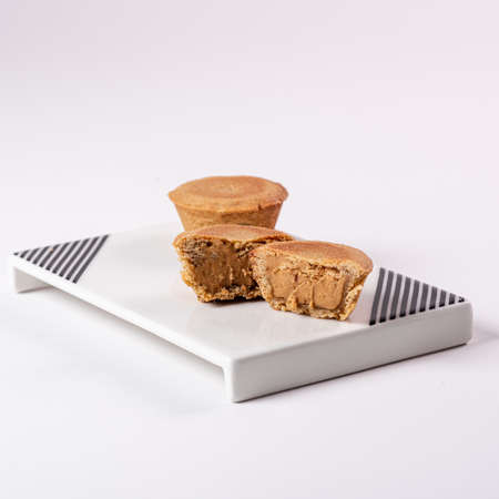 Cookies, Filled, one cut in half showing the filling and one full on a white plateの写真素材