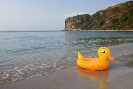 Yellow duck by the beachの写真素材