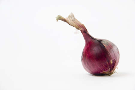 Three red onions on white background, shallow DOFの写真素材