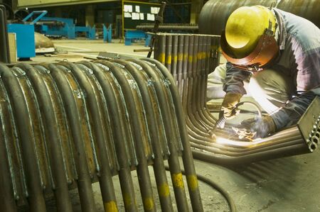 Male welder focused on job at factory