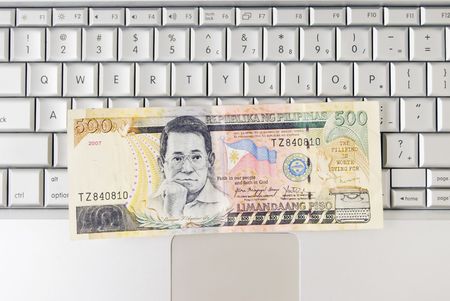 Philippine money on computer keyboard