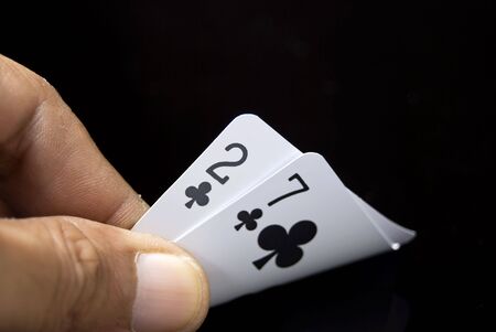 Lucky Nine cards held by hand against black backgroundの写真素材