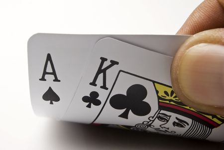 Blackjack cards held by hand against black backgroundのeditorial素材