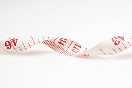 Studio shot of measuring tape against white backgroundの写真素材