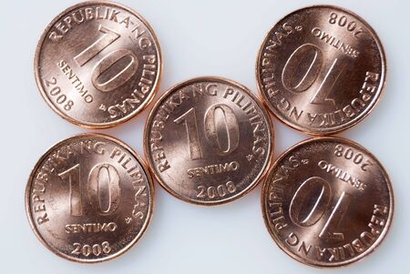 Ten-centavo Philippine coins on white backgroundの写真素材