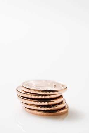 Stack of ten-centavo Philippine coins on white backgroundの写真素材