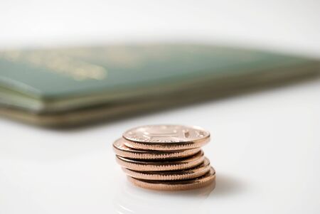 Passport and ten-centevo coins on white backgroundの写真素材