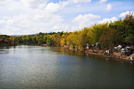 Shanties of illegal settlers on a riverbankの写真素材
