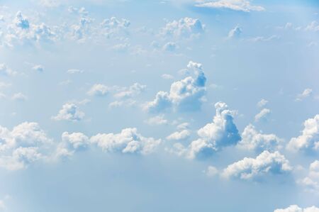 Fluffy clouds shot from airplane window
