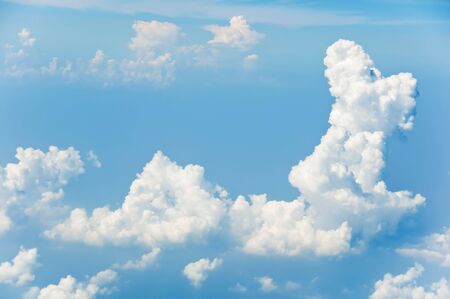 Fluffy clouds shot from airplane windowの写真素材