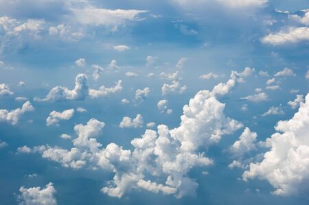 Fluffy clouds shot from airplane windowの写真素材