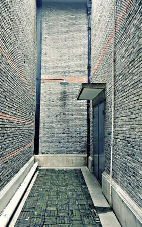 Backdoor of a big brick building in Shanghai, Chinaの写真素材