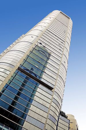 Worm's eye view of building shot against blue skyの写真素材