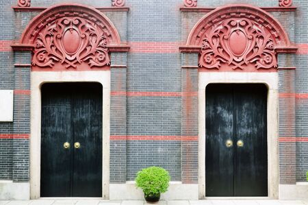 Full shot of two heavy wooden doors of an old residential structure in Shanghai, Chinaの写真素材