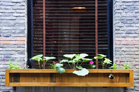 An old French residential structure with flower box outside its windowの写真素材