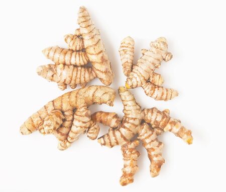 Close-up of turmeric or yellow ginger; shot against white backgroundの写真素材