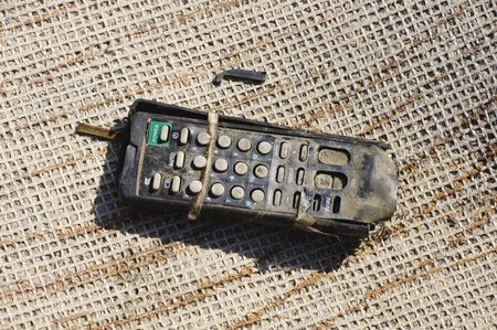 Old and discarded remote control in garbage dumpの写真素材